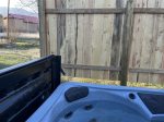 Hot Tub with privacy fence and view of church